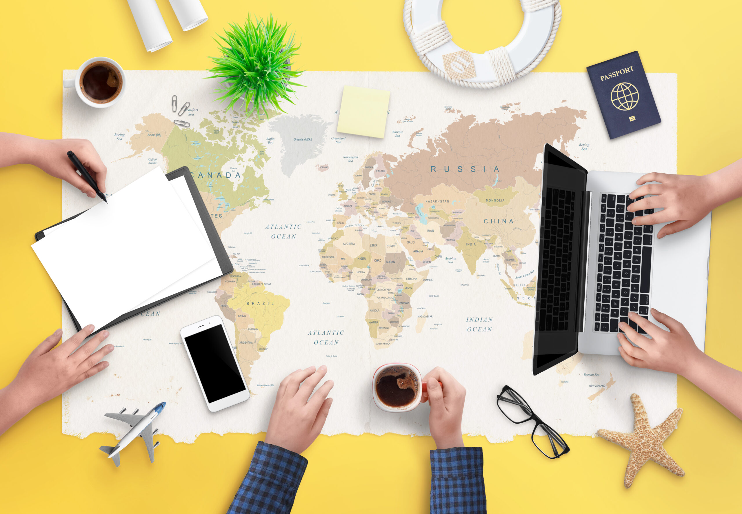 Travel agency concept of booking a trip. People working on an arrangement and airplane tickets. Top view, flat lay.